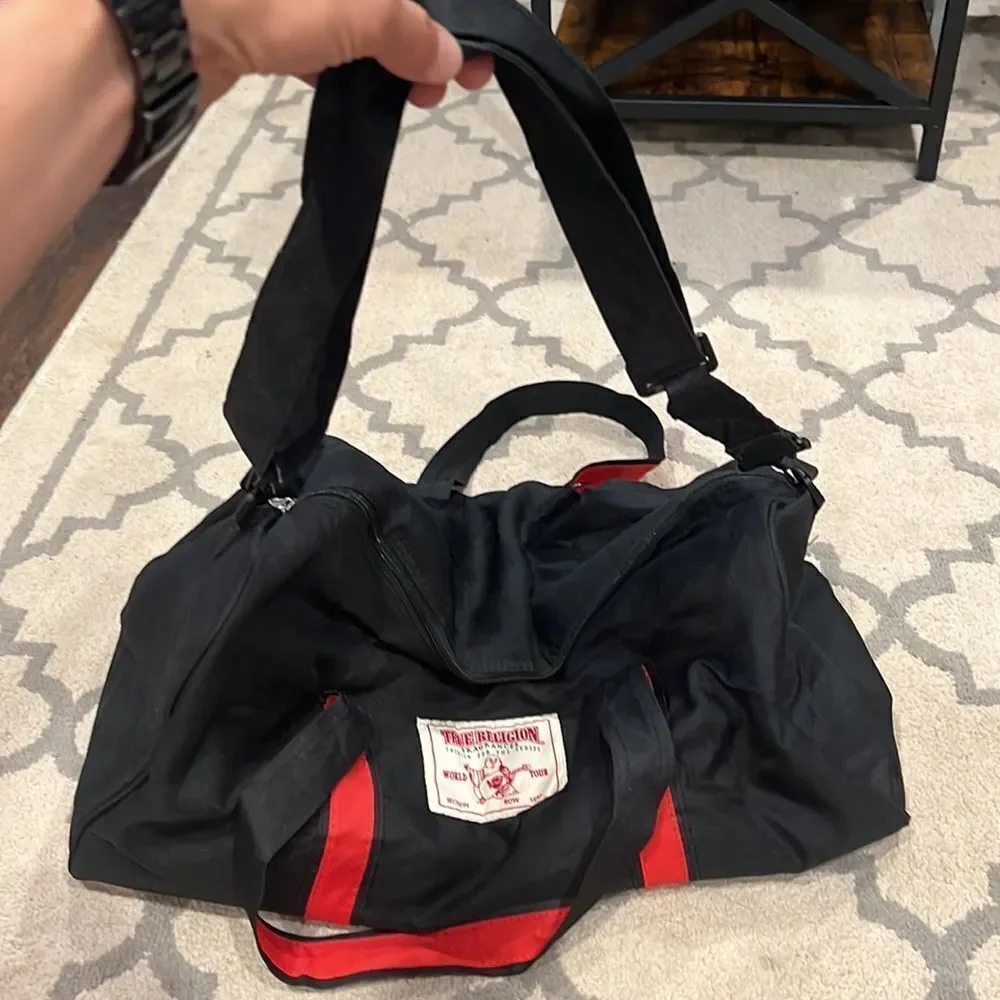 True Religion Black and Red Strap Duffel Bag